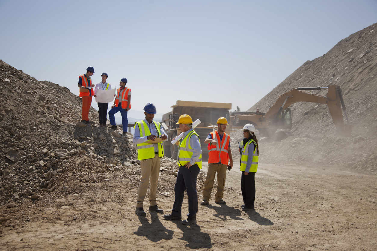 Construction project manager quoting his time and material to businesspeople looking to develop some land.